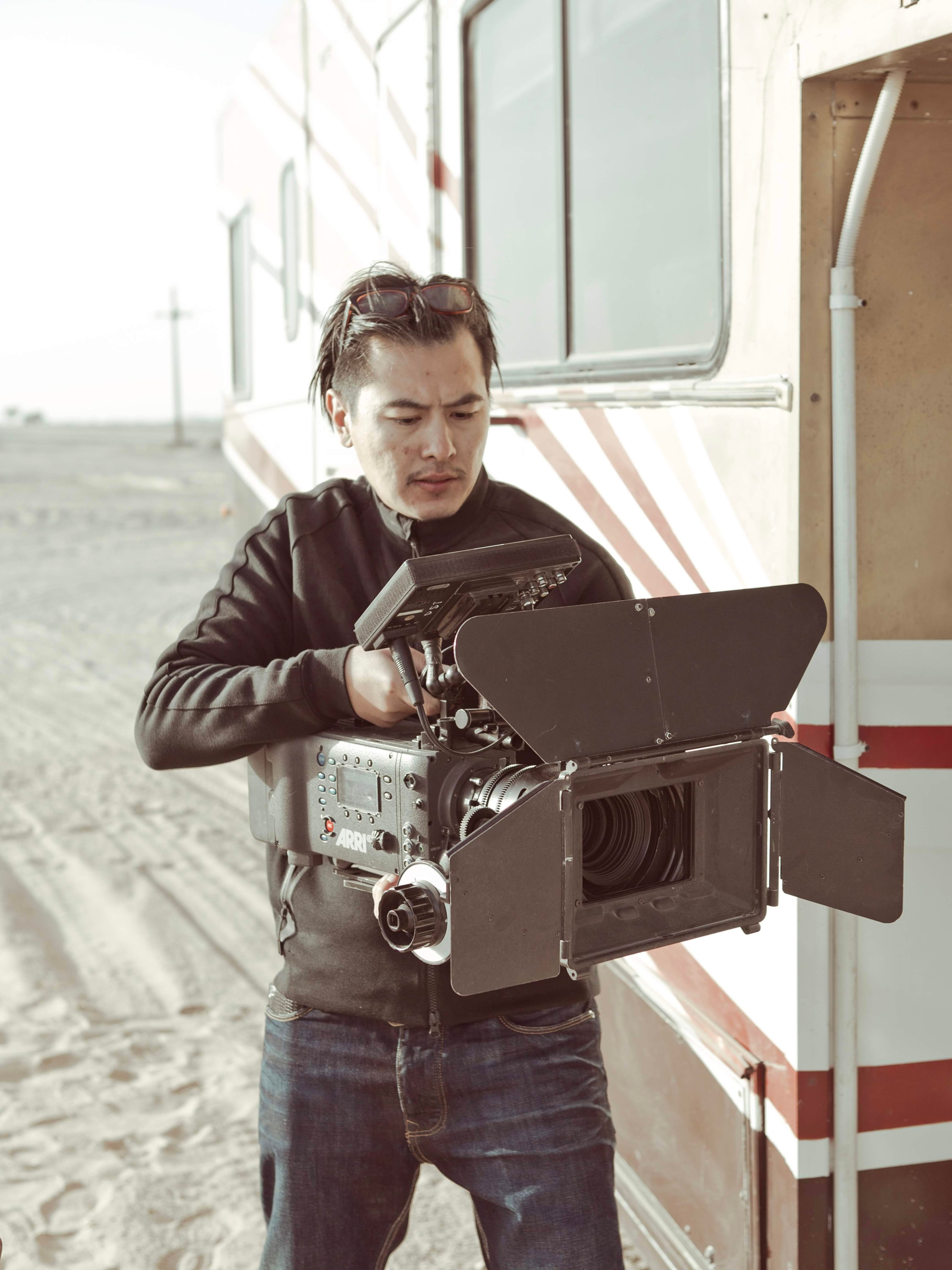Tim Primkulov operating ARRI camera on location